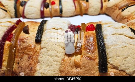 Rosca de Reyes is a traditional sweet bread decorated with crystallized fruits and hidden figures of the baby Jesus, which is shared with family Stock Photo