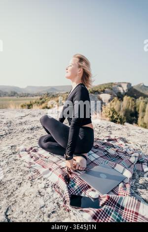 Woman Meditating on a Mountaintop Stock Photo