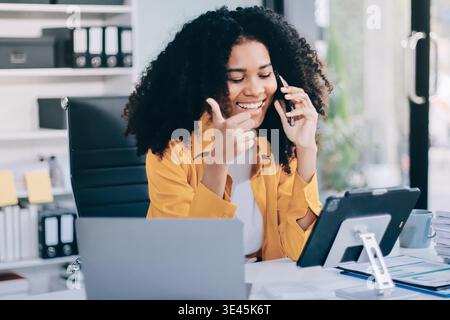 Serious, laptop and professional businesswoman sitting and reading a work email with a pen working from home. Business, computer and focused female la Stock Photo
