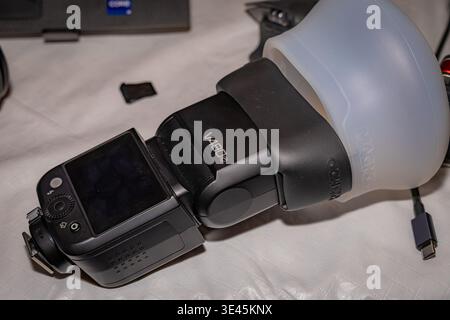 Close-up of Godox V480 camera flash with diffuser attached showing portable photography lighting gear on tabletop Stock Photo
