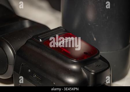 Macro closeup of Godox flash unit branding on black surface showing ...