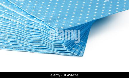 Many layers of blue napkins with white dots stacked neatly on a flat surface Stock Photo
