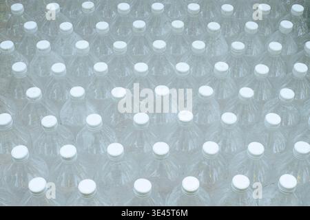 Several empty clear plastic bottles were stacked in a row. Stock Photo