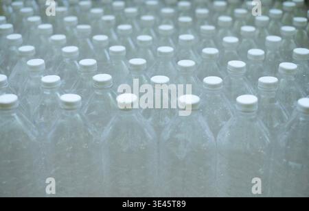 Several empty clear plastic bottles were stacked in a row. Stock Photo