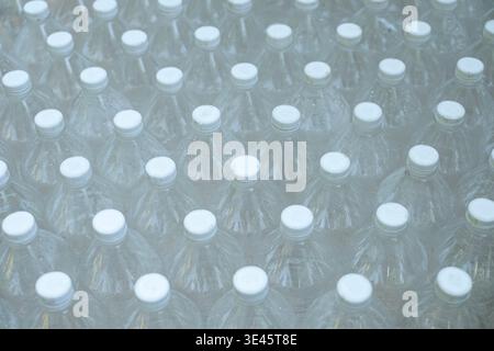 Several empty clear plastic bottles were stacked in a row. Stock Photo