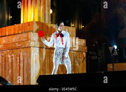 Venice, Italy - February 07, 2026: Performer wearing a white shirt and red bow tie holds a red disc on stage at the Venice Carnival opening show Stock Photo