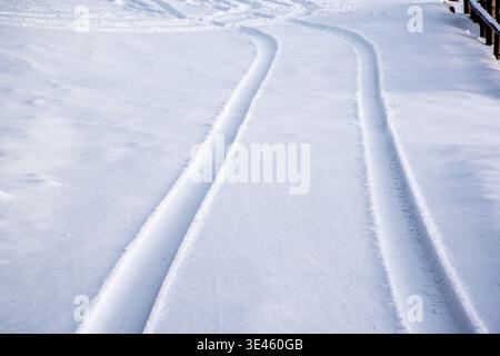 car tracks imprinted on fresh snow on the Asiago plateau in the province of Vicenza, Italy Stock Photo