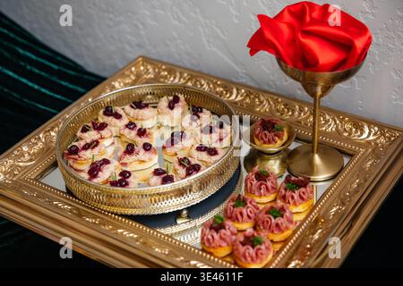 Catering serving elegant appetizers and canapes on golden trays Stock Photo