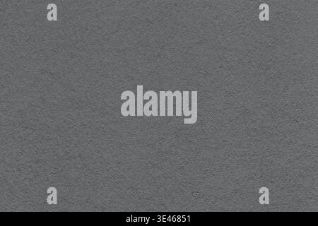 Dark gray textured paper background with subtle grain surface and soft structure. Graphite backdrop, macro. Stock Photo