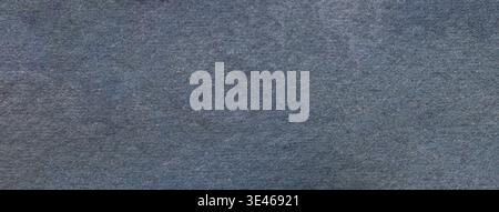 Slate blue textured paper background with subtle grain surface and soft structure. Dark gray backdrop, macro. Stock Photo