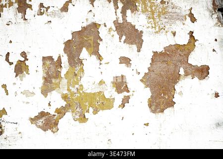 Abstract white wall background with peeled yellow paint stains and copy space Stock Photo