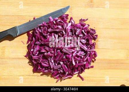 finely chopped red cabbage on the chopping board Stock Photo