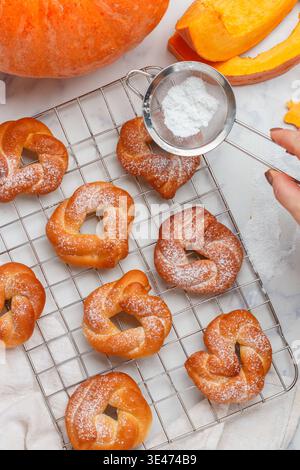 Freshly baked homemade sweet pumpkin buns with cinnamon and powdered sugar. Pumpkin pastries. Healthy autumn dessert. Halloween. Thanksgiving day. Mar Stock Photo