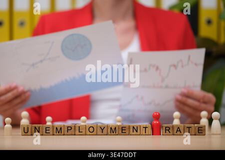 Understanding the unemployment rate through graphs and statistics in a busy office environment Stock Photo
