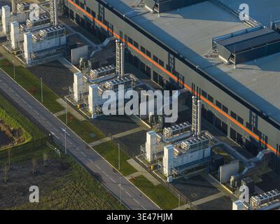 Aerial view of data center building showcasing infrastructure and multiple external cooling units in an industrial area, representing internet ai comm Stock Photo