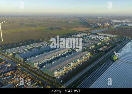 Aerial view of modern data center complex processing vast amounts of information, integrating technology with renewable wind energy in an agricultural Stock Photo