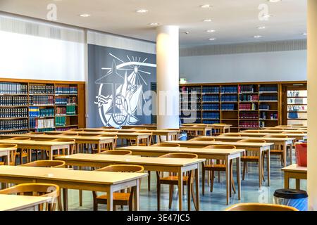 The reading room of the German National Library from the 1960s, featuring angular kidney-shaped tables and wall decorations typical of the GDR. Leipzig, Saxony, Germany Stock Photo