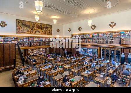 The first reading room at the German National Library in Leipzig, featuring green reading lamps and a green linoleum work surface. The walls are adorned with frescoes depicting Late Nazarene motifs. Leipzig, Saxony, Germany Stock Photo