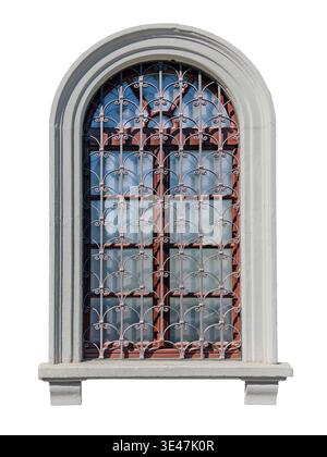 Round-arched window with wrought-iron grilles decorated in Baroque style, set within a monumental frame of plastered masonry.  Eclectic-style structur Stock Photo