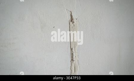 Raw concrete wall with a vertical groove during renovation process. Stock Photo