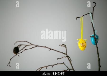 Hanging Easter egg decorations on branches, part of a traditional Easter tree display for spring celebrations. Stock Photo