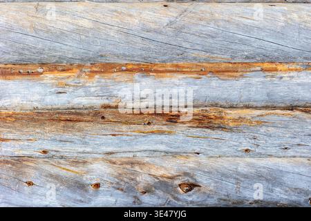 A close view of weathered kelohonka logs showing natural grain, aged surfaces and rustic Nordic character. The organic texture and varied tones make t Stock Photo