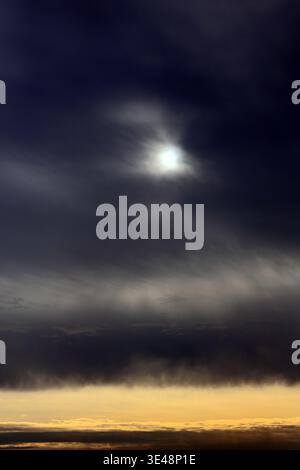 Sunlight Breaking Through Dark Clouds Stock Photo