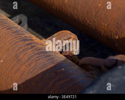 Close-up of rusty metal pipes and chains. Stock Photo