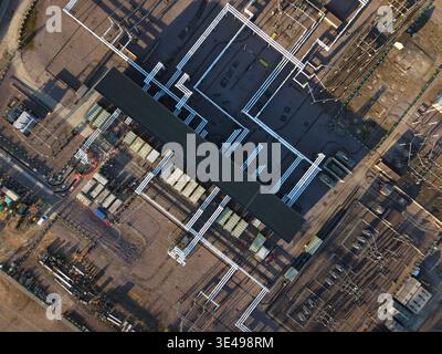Aerial view of geometric patterns of pipes and structures under the sun's gaze, Bramford, Ipswich, United Kingdom. Stock Photo