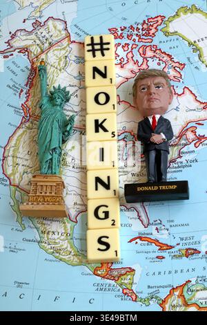 Hashtag NoKings in Scrabble-style tiles on map of North America with Donald Trump figurine and Statue of Liberty, conceptual political protest image Stock Photo