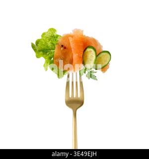 Salted smoked red salmon fish slice, fresh lettuce salad leaf, cucumber pieces and herbs on golden fork isolated on white background. Healthy food. Stock Photo