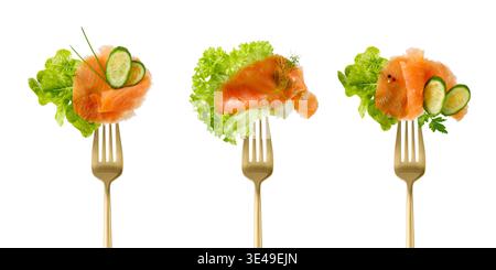 Salted smoked red salmon fish slice, fresh lettuce salad leaf, cucumber pieces and herbs on golden fork isolated on white background. Set of salmon sl Stock Photo