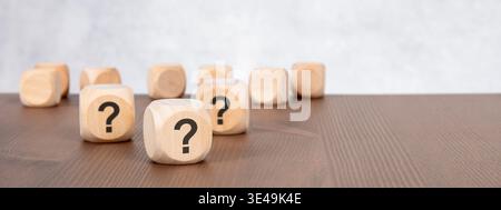 Question mark wooden blocks on desk. Concept of FAQ, technical support, helpdesk, questions and answers. Stock Photo