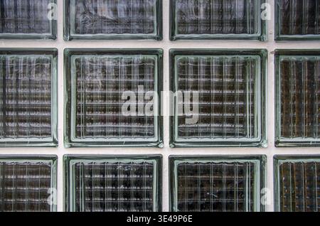 Glass block wall creating a textured pattern with architectural transparency Stock Photo