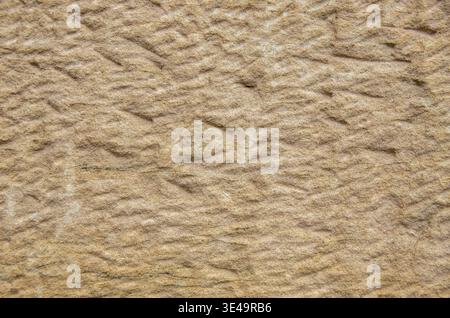 Sandstone surface showing a natural rock texture and earthy beige color Stock Photo
