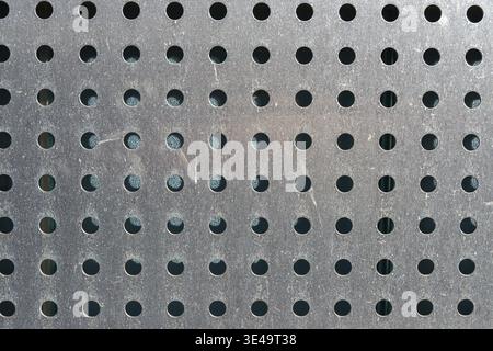 Perforated stainless steel sheet as background or texture Stock Photo