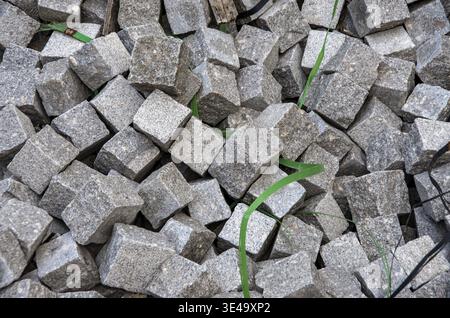 Granite paving stones piled up, ready for urban road and pathway construction Stock Photo