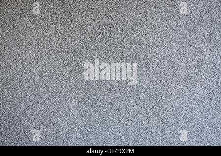 Stucco wall texture creating a gray background with rough, granular surface details Stock Photo