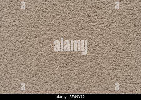 Beige colored stucco wall rough textured surface Stock Photo