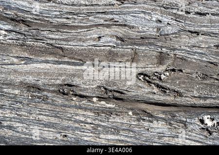 Detailed view of abstract rock texture with wavy, eroded layers and natural patterns Stock Photo