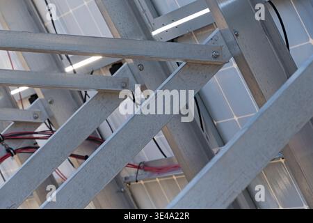 detail of aluminum solar panel supports on the back side of a solar photvoltaic array Stock Photo