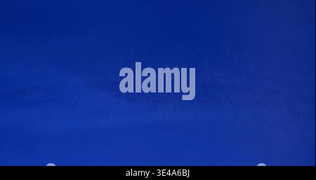 Blue background shows a simple pattern with smooth texture appearing almost like a fabric or wall at different angles and light Stock Photo