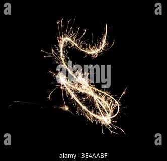 Abstract S-Shaped Sparkler Golden Light Trail on Black Background Stock Photo
