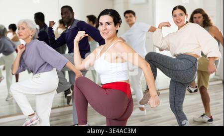 Young Hispanic woman practicing vigorous dance movements Stock Photo