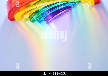 Rainbow spectrum light refracting through glass prism Stock Photo