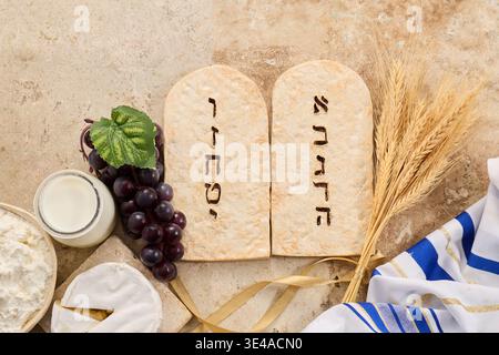 Shavuot holiday showing torah tablets and common food items Stock Photo