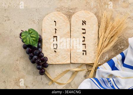 Shavuot concept with tablets, wheat, grapes, and tallit Stock Photo