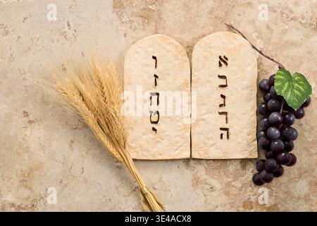 Shavuot celebration showing torah tablets wheat grapes Stock Photo