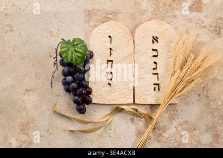Shavuot ten commandments tablets with grapes and wheat Stock Photo