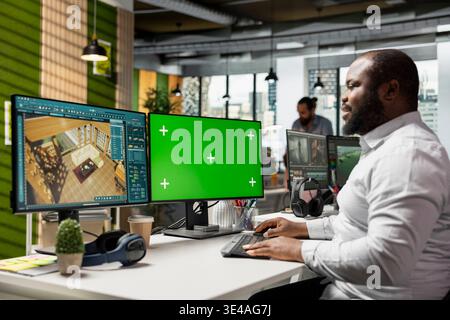 Green screen and architectural CAD software on dual monitors in creative agency, modern apartment floor plan. Professional developing a layout and 3D rendering of interior design in office. Stock Photo